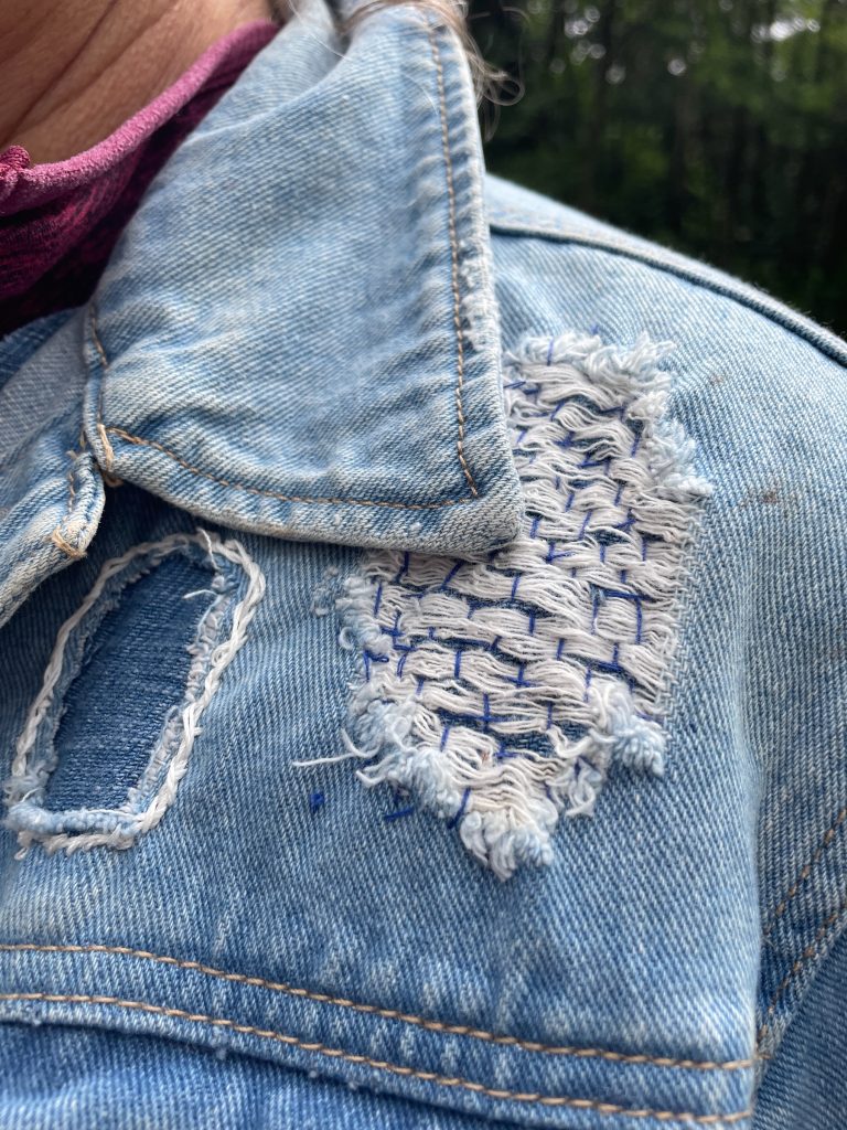 Close-up of sashiko stitch pattern on denim collar.