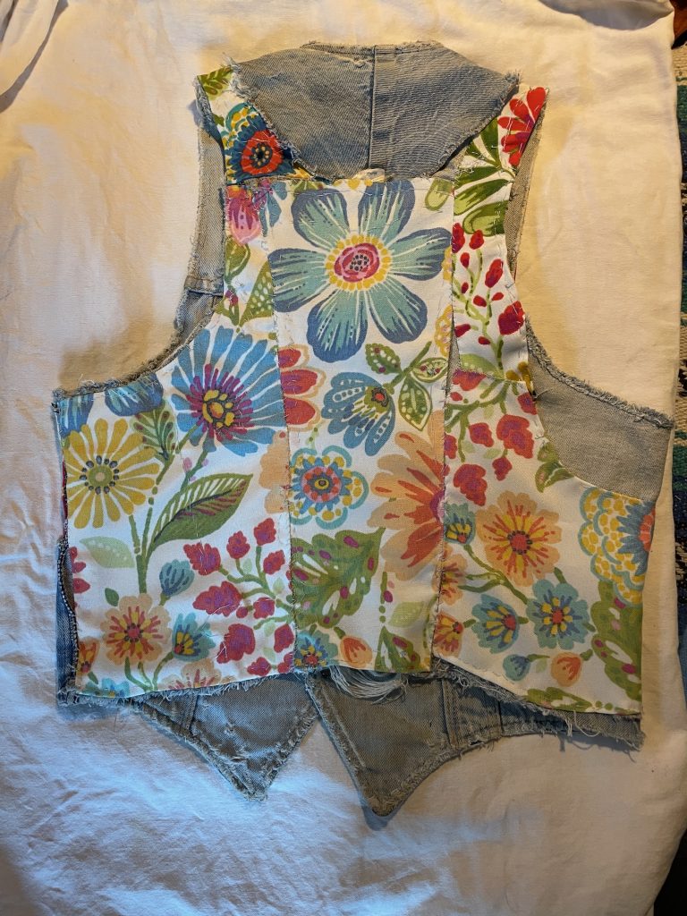 Denim vest interior with bright floral paneling on back.