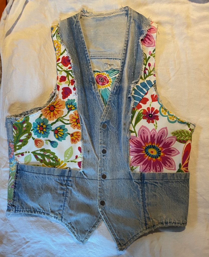 Denim vest front interior with floral cotton panels.